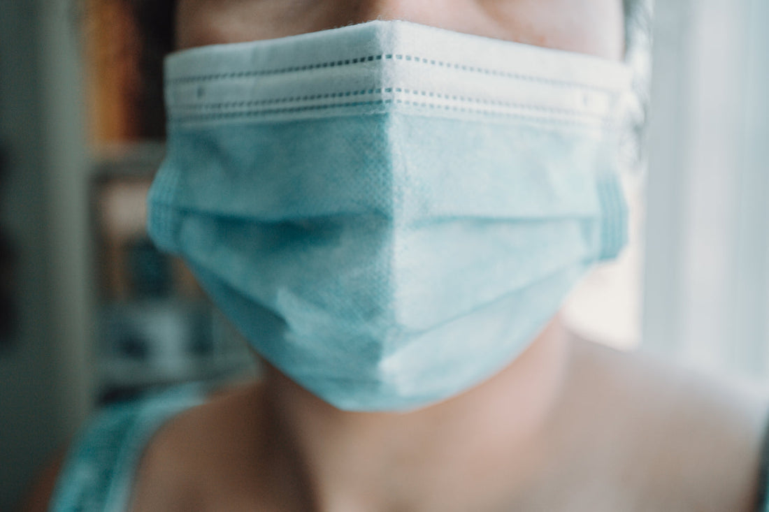 Image of face wearing surgical mask, blue 